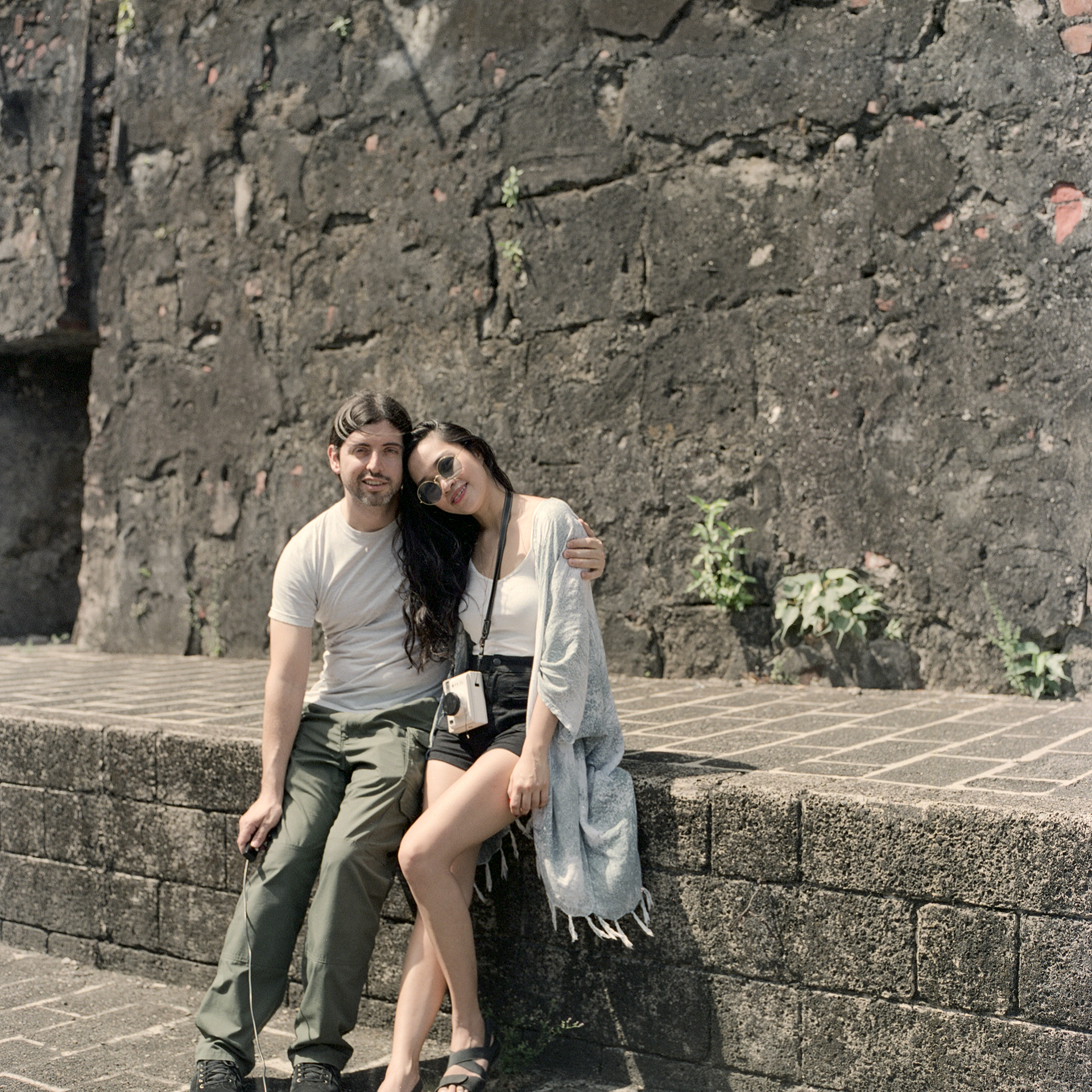 Zab and I sitting on a ledge near an inner wall at Fort Santiago