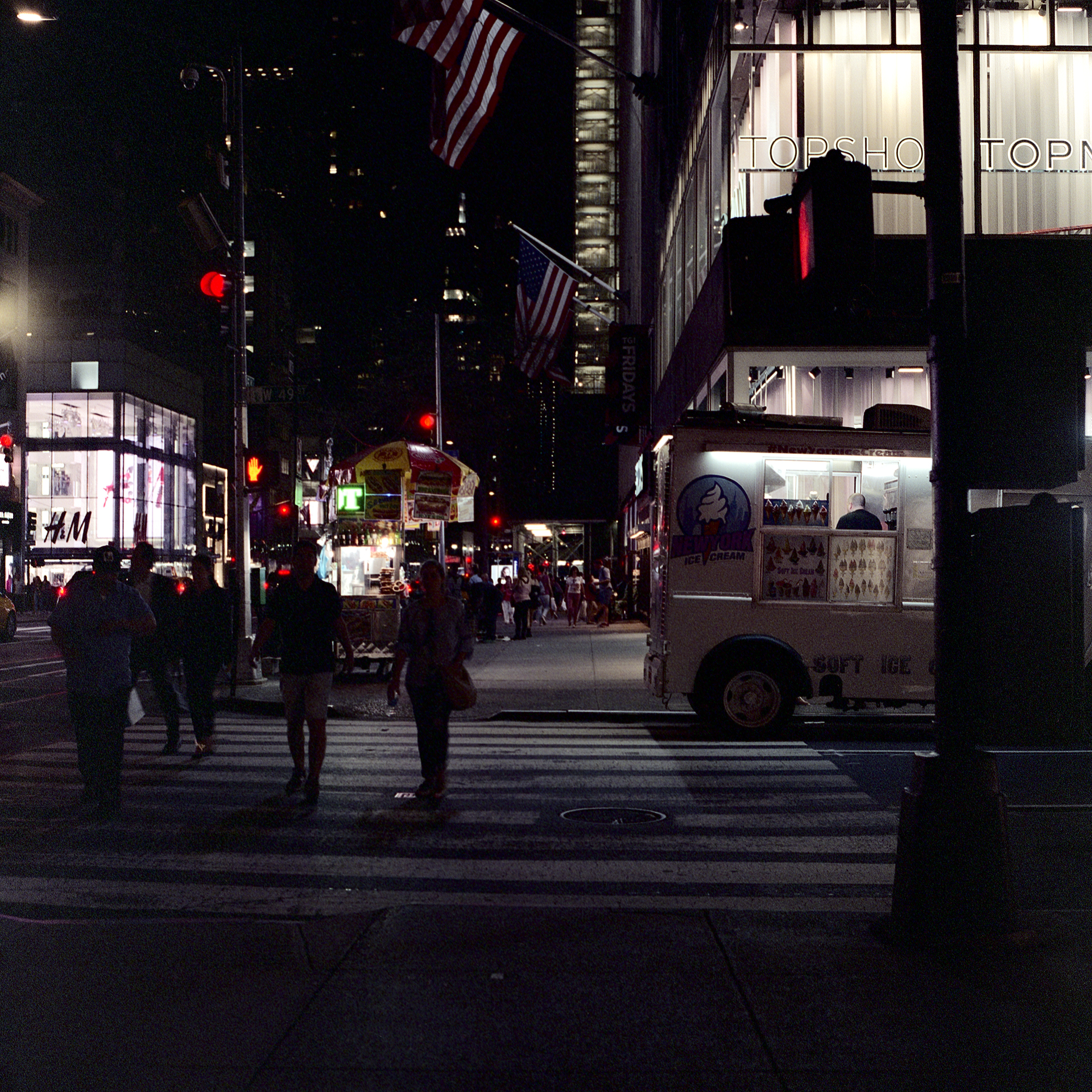 People crossing at night at the intersection of 49th and 5th Ave in Manhattan